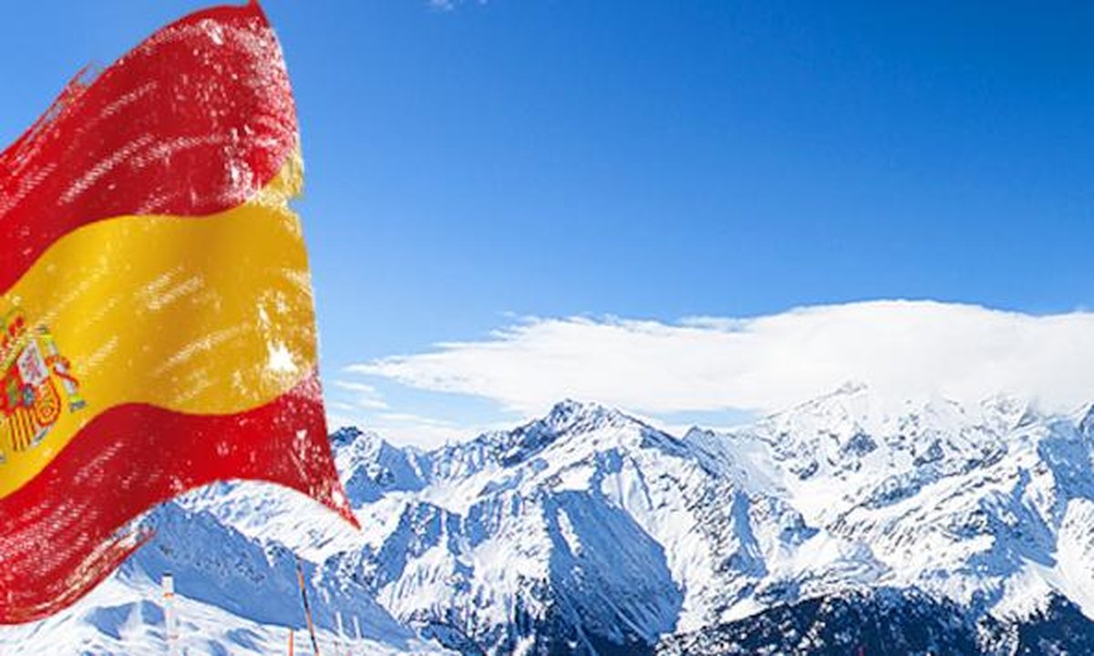 Snow-covered Spanish ski resort slopes with chairlift and alpine village