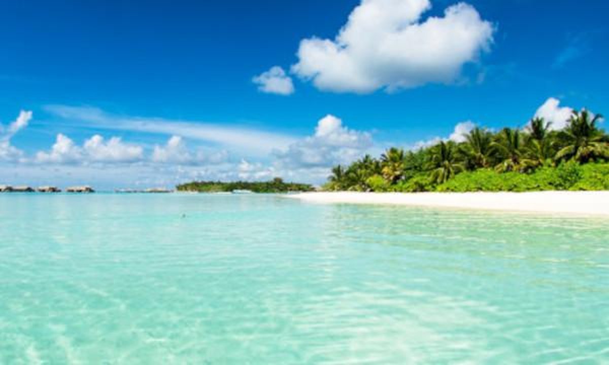 Split image showing Spain's beach and Dubai skyline with Burj Khalifa