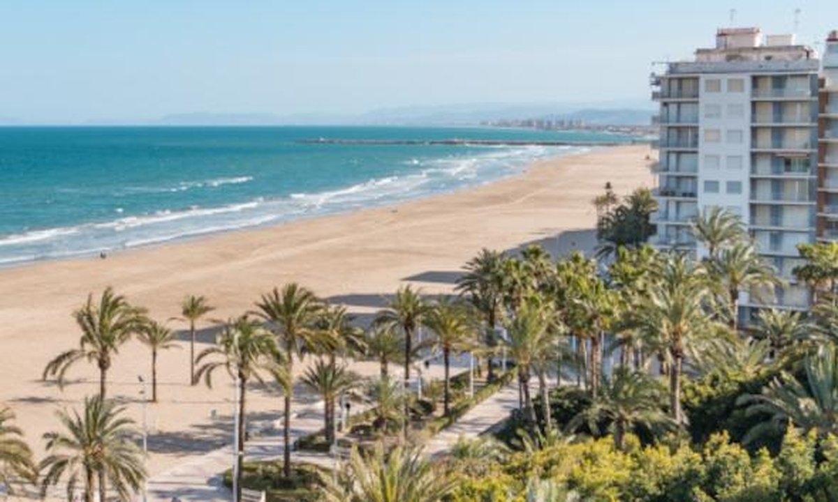 Affordable coastal Spain apartment for sale showing keys and price tag