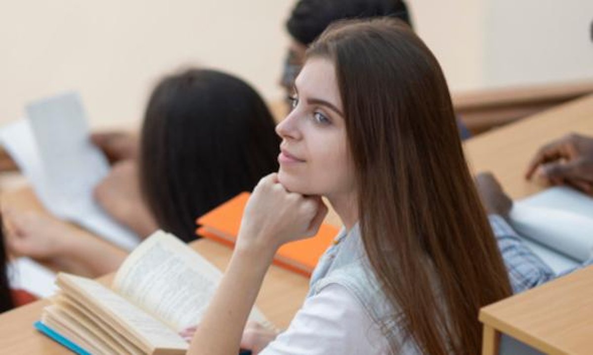 Students studying on a Spanish university campus with historic architecture